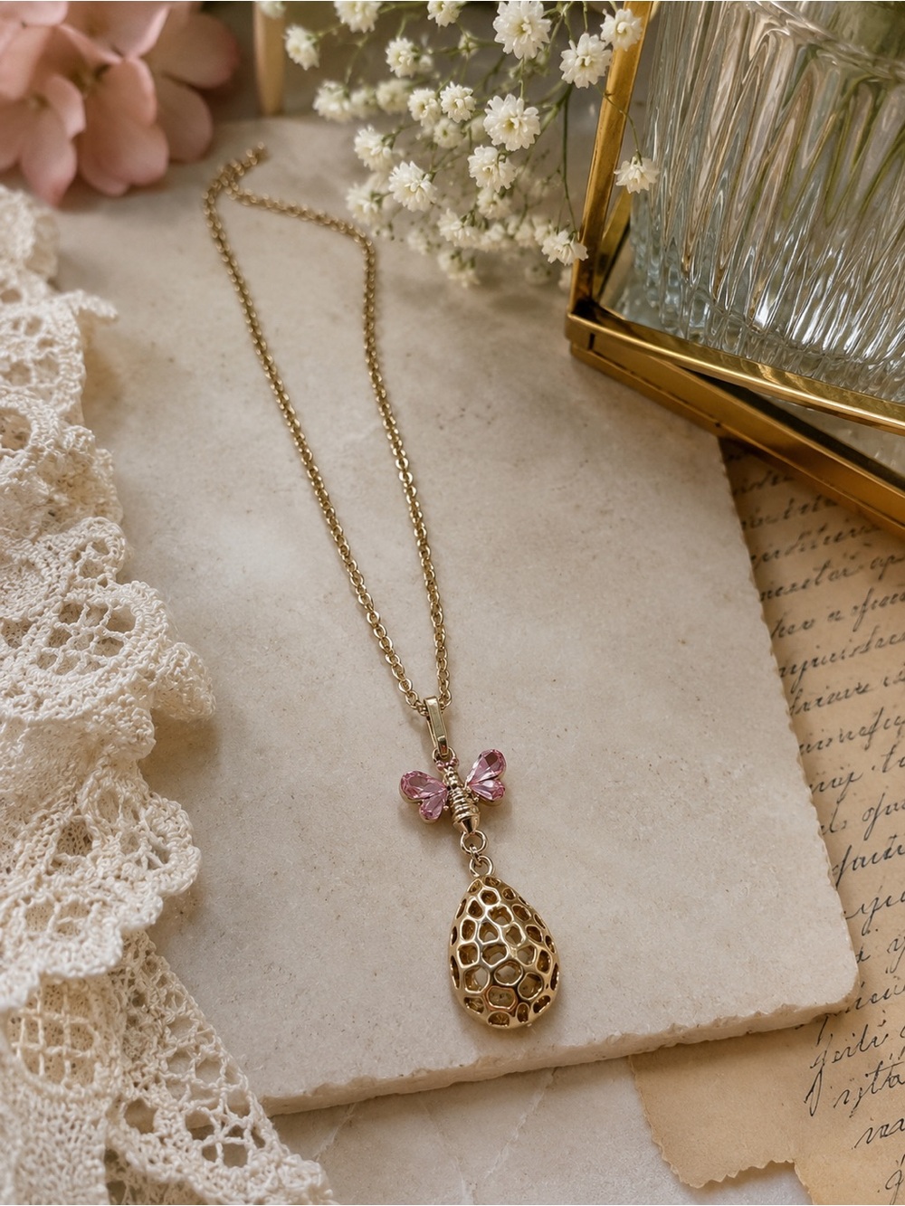 Gold Tone Teardrop Pendant Necklace with Pink Crystal Bow